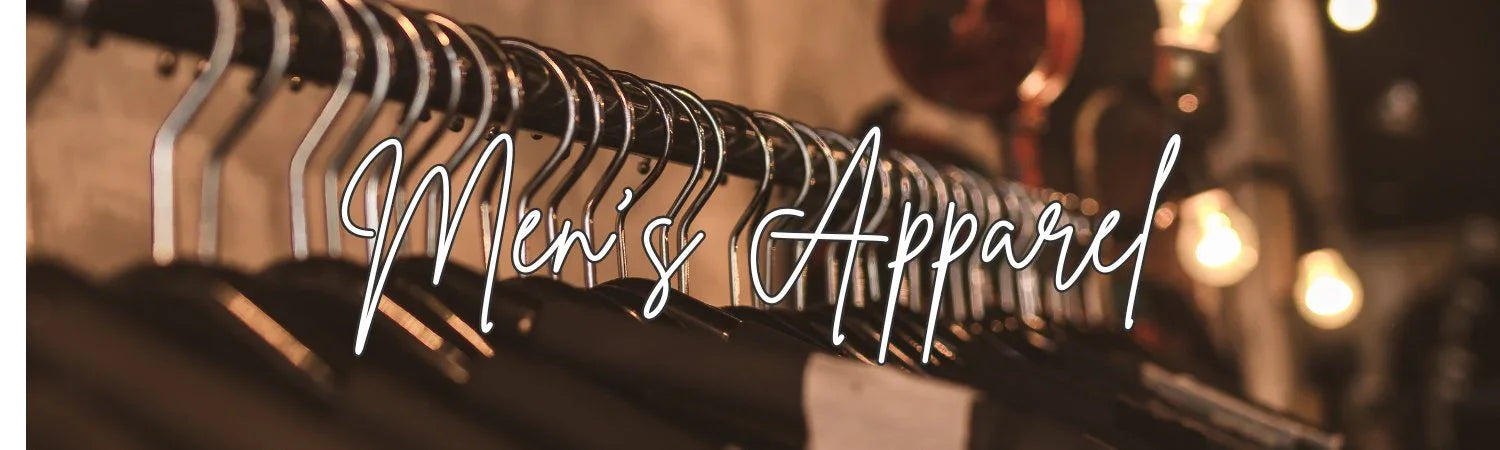 Row of black men's apparel shirts hanging on metal hangers in a dimly lit store