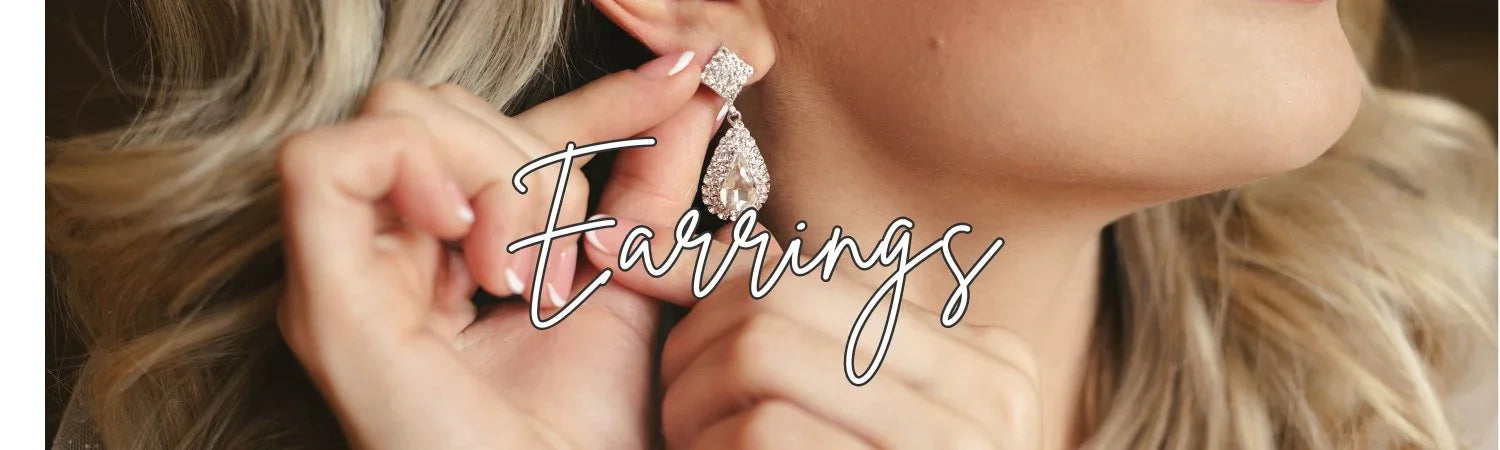 Close-up of woman with blonde hair wearing and adjusting sparkling teardrop crystal earrings