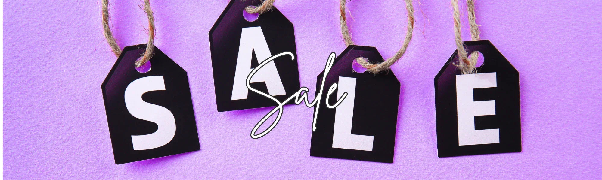 Black sale tags with white letters on purple background, word Sale in bold and script styles