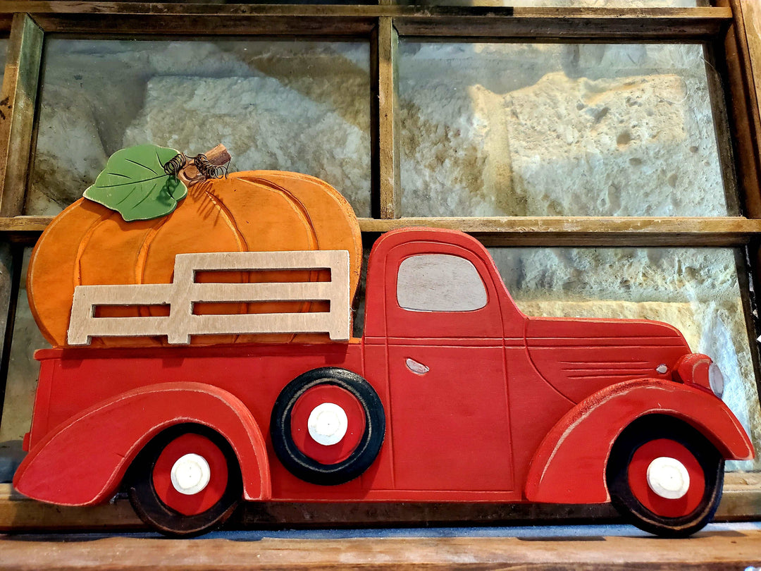 Red farm truck with pumpkin